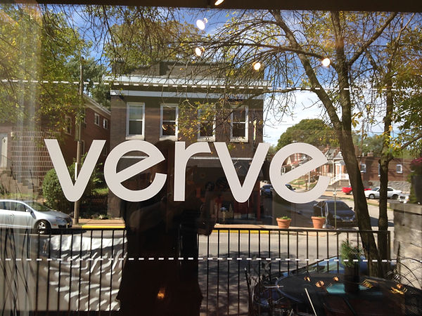 The word verve in white letters on the front window, with the street beyond